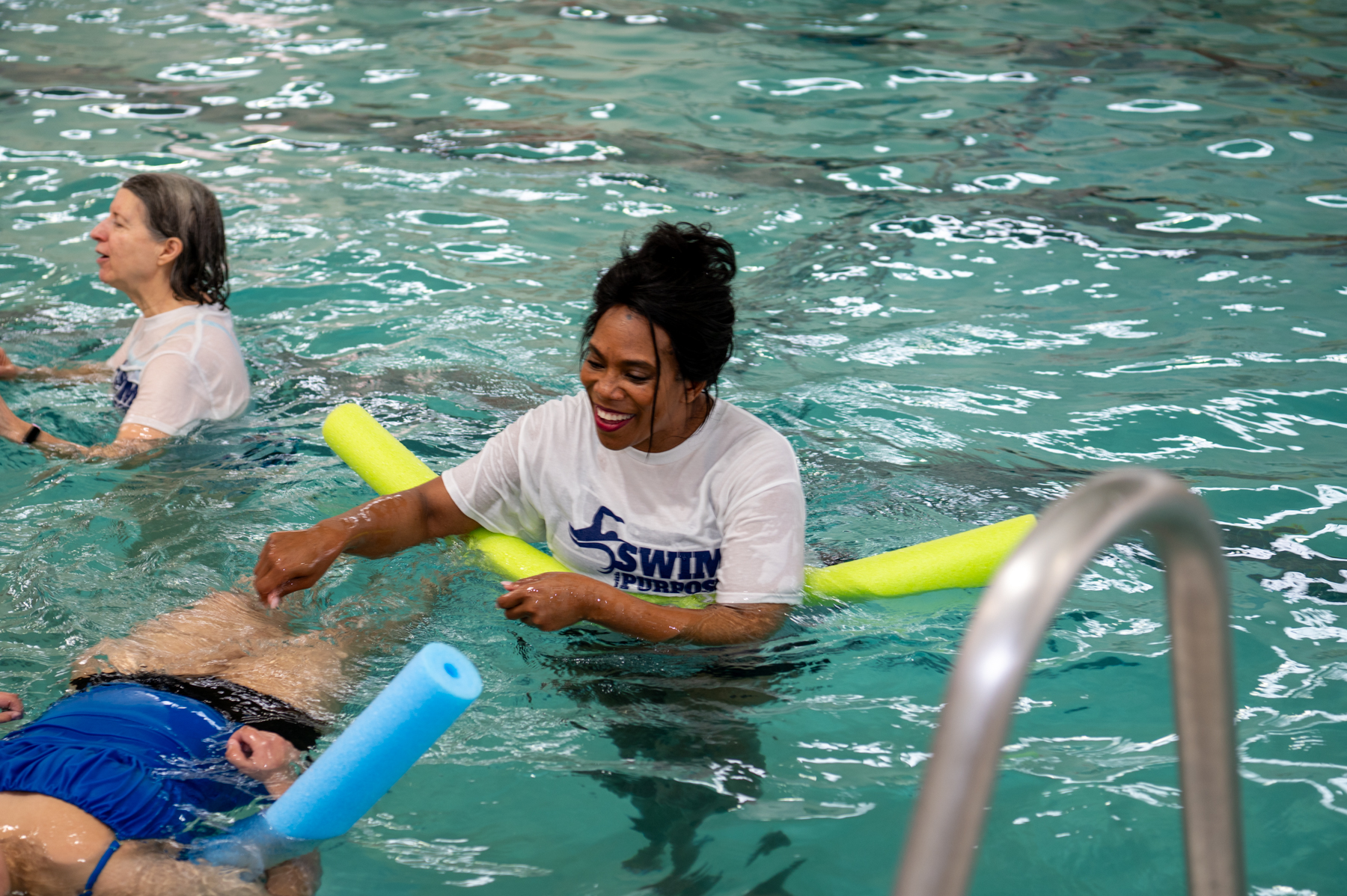 Swim instructor working with student